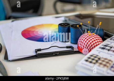 Sewing machine and accessories on table at dressmaking workshop studio Stock Photo
