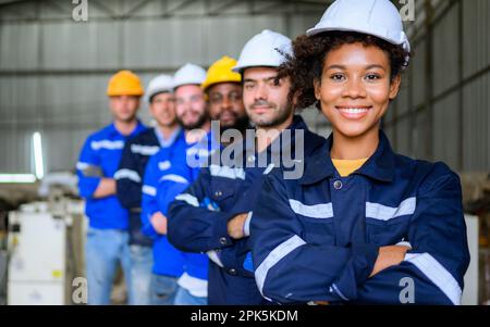 Group of professional engineers workers smiling to camera at factory Stock Photo