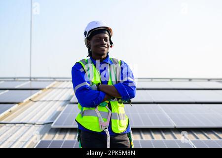 Smiling portrait of happy engineer technician working on rooftop Stock Photo