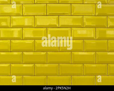 Yellow rectangular ceramic tiles wall texture. Stock Photo