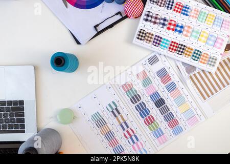 Sewing machine and accessories on table at dressmaking workshop studio Stock Photo