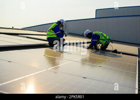Engineer and technician using laptop checking solar panels system  Stock Photo