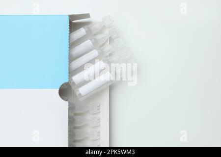 Package with single dose ampoules of sterile isotonic sea water solution on white background, top view. Space for text Stock Photo