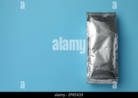 Blank foil package on light blue background, top view. Space for text Stock Photo