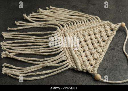 Stylish beige macrame on grey table, closeup Stock Photo