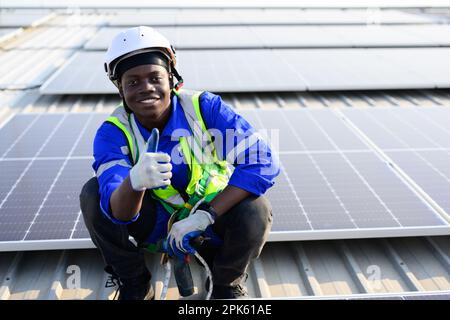 Smiling portrait of happy engineer technician working on rooftop Stock Photo