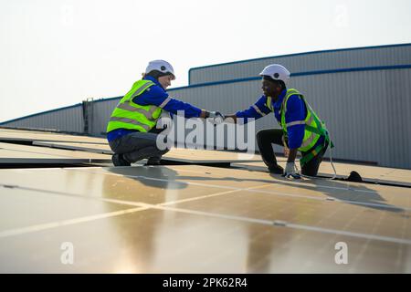 Two engineers technicians shacking hands together with successful project  Stock Photo
