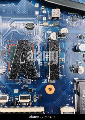 AI short for Artificial Intelligence in black lettering on a laptop computer motherboard to give a tech vibe Stock Photo