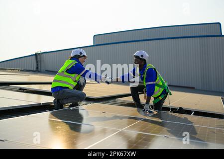 Two engineers technicians shacking hands together with successful project  Stock Photo