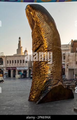 The Golden Thumb Statue, Souq Waqif, Doha, Qatar, with the Fanar Qatar ...