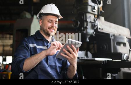 Professional male technician engineer using tablet checking machine Stock Photo