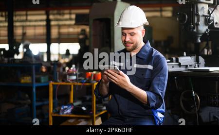 Professional male technician engineer using tablet checking machine Stock Photo