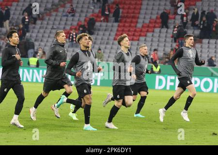 MUNICH, GERMANY - APRIL 04: goal 1:2 by penalty - Sc Freiburg eliminates FcBayern from the DFB-Cup 2023 - Players of Freiburg celebrate the victory with Lucas HÖLER, Hoeler, during the DFB Cup quarterfinal match between FC Bayern München and SC Freiburg at Allianz Arena on April 04, 2023 in Munich, Germany. the players; #26 Mark FLEKKEN, Keeper, #5 Manuel GULDE, #8 Maximilian EGGESTEIN, #9 Lucas HÖLER - Hoeler, #25 Kilian SILDILLIA, #27 Nicolas HÖFLER, Hoefler, #28, Matthias GINTER, #30 Christian GÜNTER -  Guenther, #32 Vicenzo GRIFO, #38 Miachael GREGORITSCH, #42 Ritsu DOAN, #22 Roland SALLAI Stock Photo