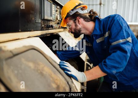 Engineer technician controlling robotic arms on computer laptop Stock Photo