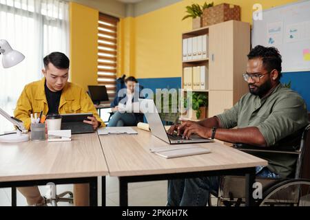 Diverse business team working on big project in office Stock Photo
