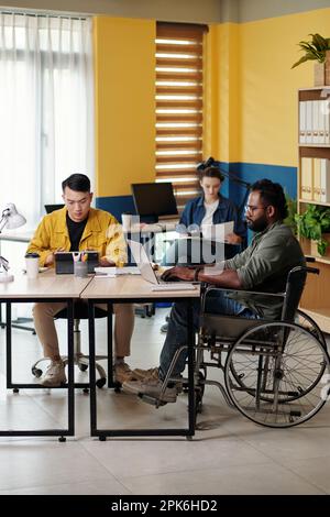 Diverse marketing team working in office on big project Stock Photo