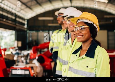 Group of confident engineers workers smiling at factory Stock Photo