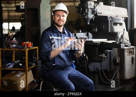 Professional male technician engineer using tablet checking machine Stock Photo