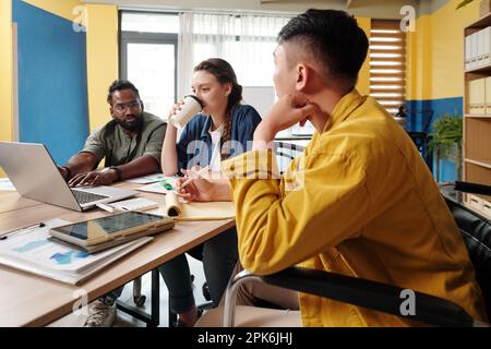 Diverse business team having brainstorming session in the morning Stock Photo