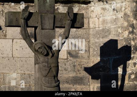 Stone cross with shadow cast, cathedral cemetery near Cologne Cathedral, Cologne, North Rhine-Westphalia, Germany Stock Photo