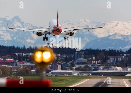 Aircraft on landing, Helvetic Airways, Embraer ERJ-190LR, Snow covered Alps, ZRH Airport, Zurich, Switzerland Stock Photo