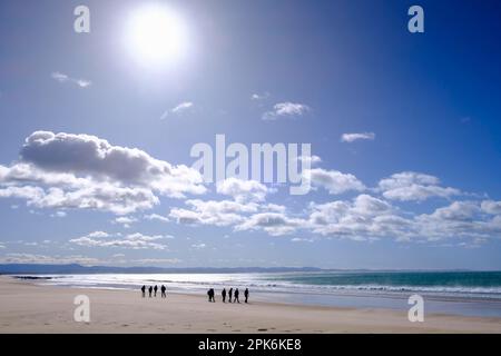 Beach walkers, Jeffreys Bay near Port Elizabeth, Garden Route, Eastern Cape, South Africa Stock Photo