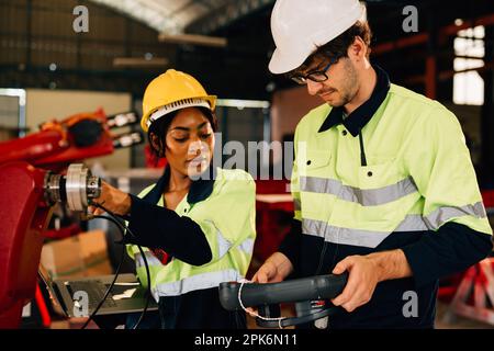 Happy male and female mechanical engineers in hard hat and safety uniform Stock Photo