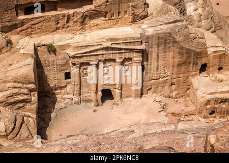 The Royal Tombs of Petra embody the unique artistry of the Nabateans while also giving display to Hellenistic architecture, but the façades of these tombs have worn due to natural decay. One of these tombs, the Palace Tomb, is speculated to be the tomb for the kings of Petra. The Corinthian Tomb, which is right next to the Palace Tomb, has the same Hellenistic architecture featured on the Treasury. The two other Royal Tombs are the Silk Tomb and the Urn Tomb; the Silk Tomb does not stand out as much as the Urn Tomb. The Urn Tomb features a large yard in its front, and was turned into a church Stock Photo