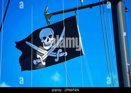 Pirate flag on sailboat, Highbourne Cay, Exuma Cays, Bahamas Stock Photo