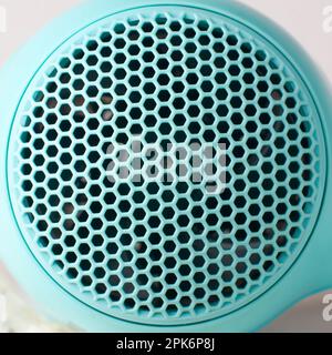 close-up of hair dryer air inlet grille, abstract of plastic molding surface with grid for fan devices taken in selective focus, pattern background Stock Photo