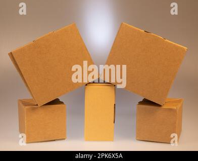 Little brown boxes in various formations on my light table Stock Photo