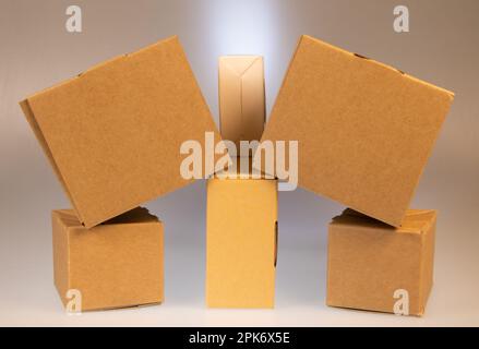 Little brown boxes in various formations on my light table Stock Photo