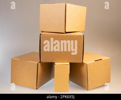 Little brown boxes in various formations on my light table Stock Photo