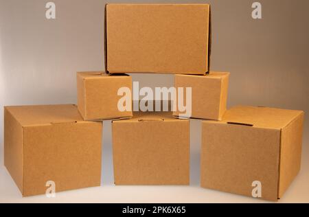 Little brown boxes in various formations on my light table Stock Photo