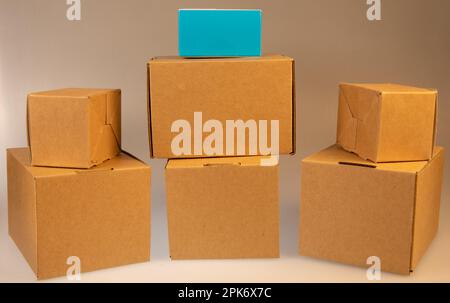 Little brown boxes in various formations on my light table Stock Photo