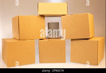 Little brown boxes in various formations on my light table Stock Photo