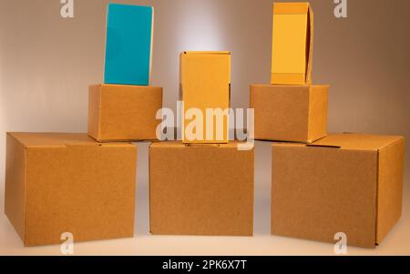 Little brown boxes in various formations on my light table Stock Photo