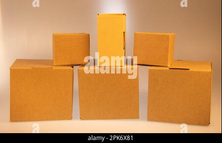 Little brown boxes in various formations on my light table Stock Photo