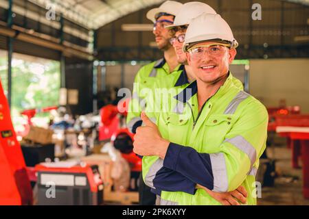Group of confident engineers workers smiling at factory Stock Photo