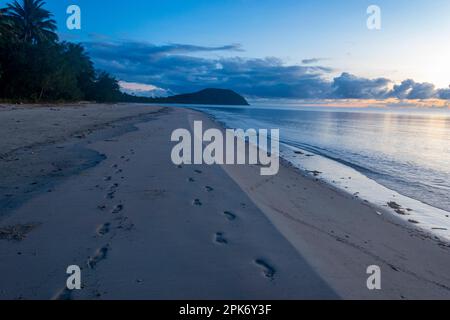 Footprints in the sand at sunrise on deserted Myall Beach, Cape Tribulation, Far North Queensland, FNQ, QLD, Australia Stock Photo