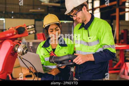 Happy male and female mechanical engineers in hard hat and safety uniform Stock Photo