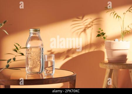 This room has a calm atmosphere with natural light. There are clay pots, glass bottles, coffee and various objects on the table. Stock Photo