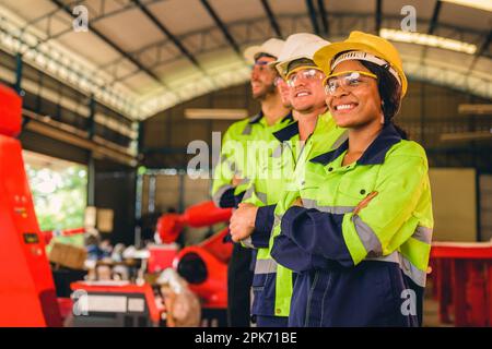 Group of confident engineers workers smiling at factory Stock Photo