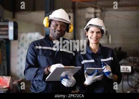 Two technicians engineers workers holding tablet checking Stock Photo