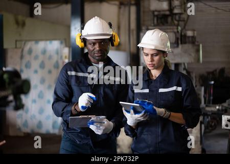 Two technicians engineers workers holding tablet checking Stock Photo
