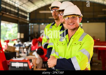 Group of technicians engineers workers posing to camera with smile Stock Photo