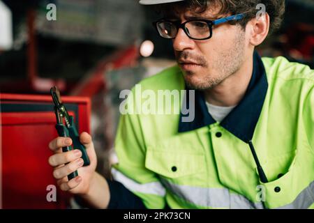 Technician engineer holding robot controller checking and repairing machine Stock Photo