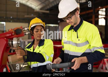 Happy male and female mechanical engineers in hard hat and safety uniform Stock Photo