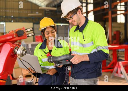 Happy male and female mechanical engineers in hard hat and safety uniform Stock Photo