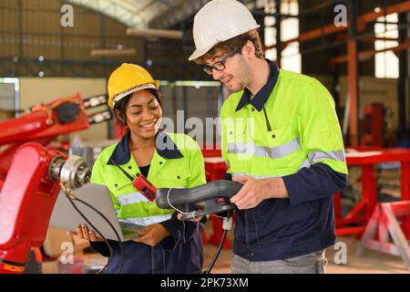 Happy male and female mechanical engineers in hard hat and safety uniform Stock Photo